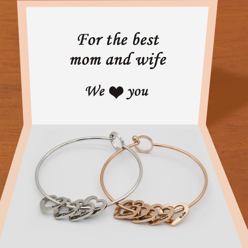 Two personalized peach heart charm bracelets from the Love Bracelet collection.