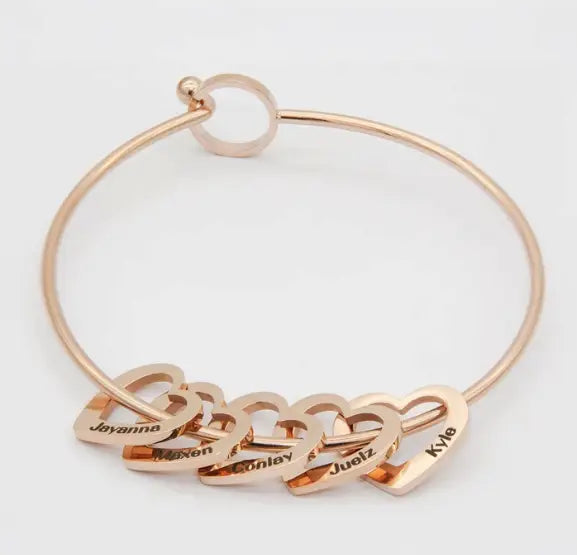 Rose gold bangle with heart charms from the Love Bracelet Peach Heart collection.