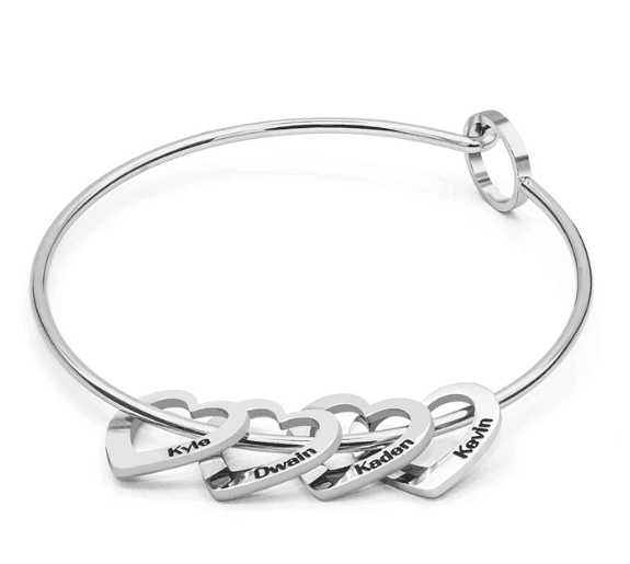 Silver bangle bracelet with peach heart charms from the Love Bracelet collection.