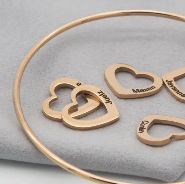 Gold-toned Love Bracelet featuring peach heart charms and personalized lettering in jewelry.