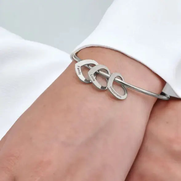 Silver bangle bracelet with heart charms from Love Bracelet Peach Heart jewelry.