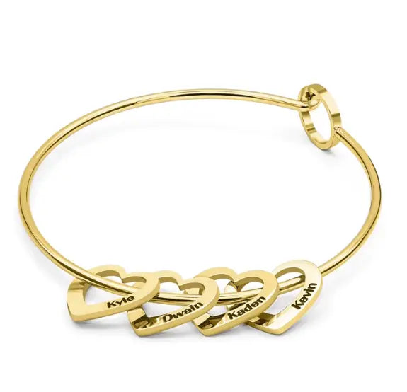 Gold-toned bangle bracelet with peach heart name charms, perfect jewelry for any occasion.