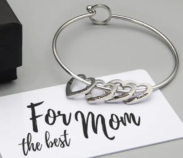 Silver bangle with heart charms from the Love Bracelet Peach Heart jewelry collection.