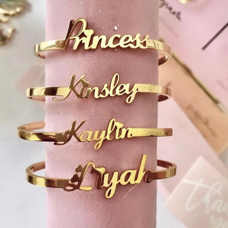 Gold-toned personalised stainless steel alphabet bracelet for young girls.