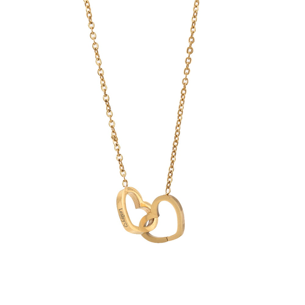 Gold-toned heart pendant necklace featuring stainless steel and custom engraved designs.