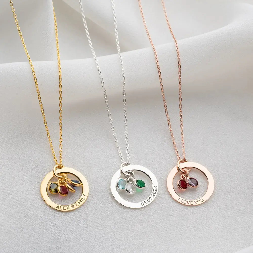 Three personalized engraved birthstone circle necklaces in Rose Gold displayed together.
