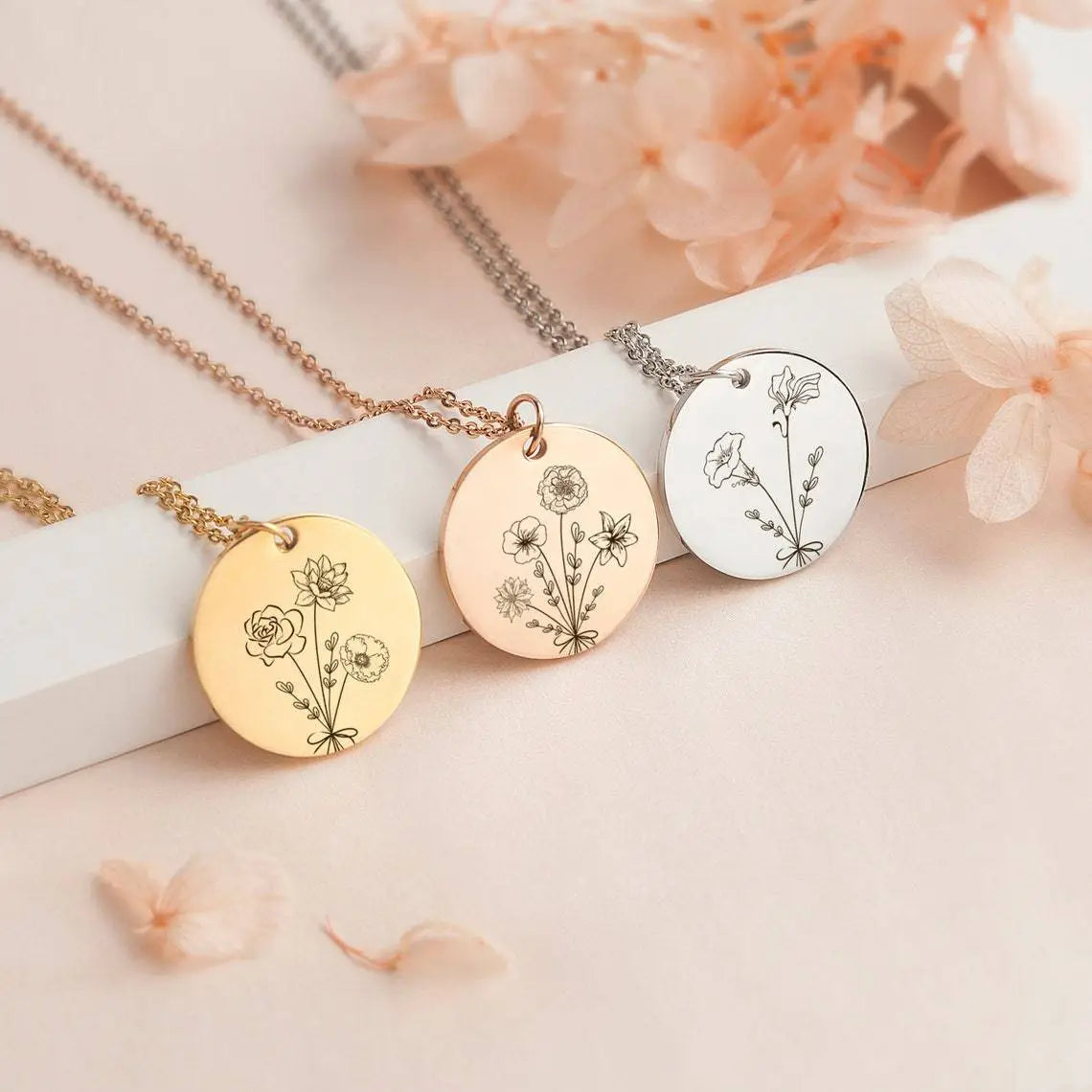 Three engraved pendant necklaces featuring Combination Birthday Flowers design.