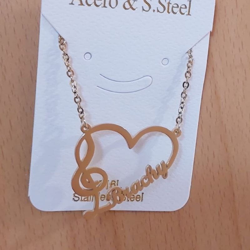 Gold-toned heart necklace with musical note and name in stainless steel jewelry.