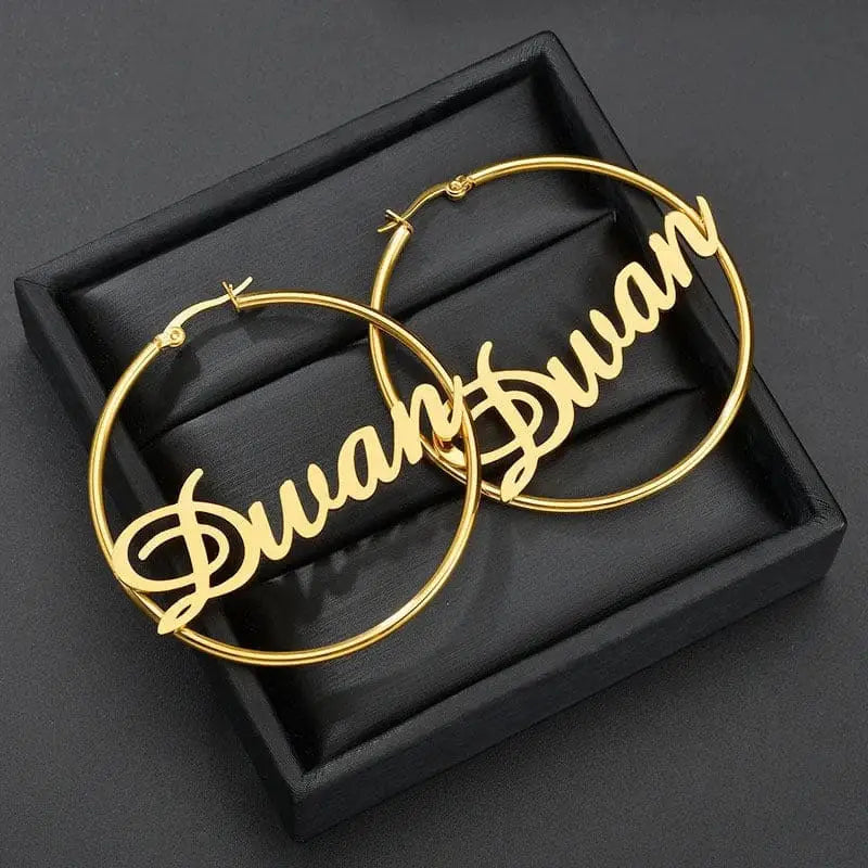 Gold hoop earrings with name showcasing Amber’s polished plating treatment process.
