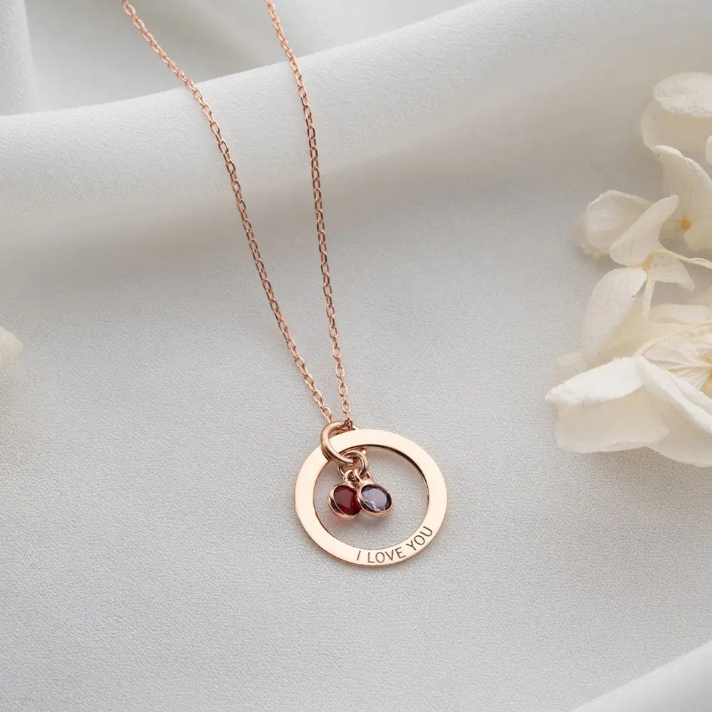 Personalized Engraved Birthstone Circle Necklace in Rose Gold with gemstone pendants.