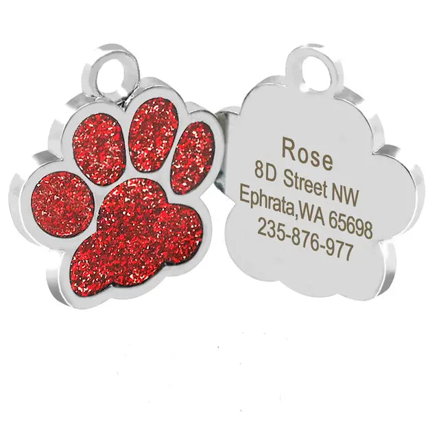 Red glitter paw print on personalized dog tag for engraved cat and puppy identification.