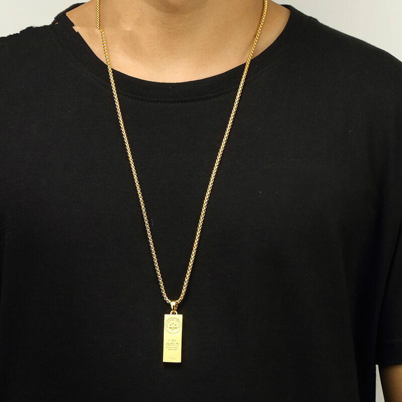 Gold chain necklace with rectangular pendant perfect for trendy jewelry lovers.